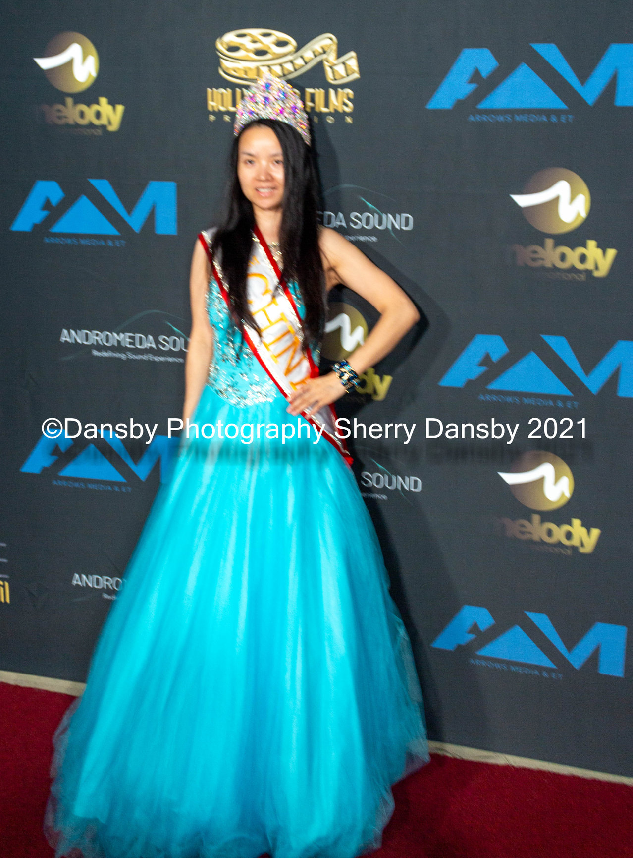 A client posing at a red carpet event