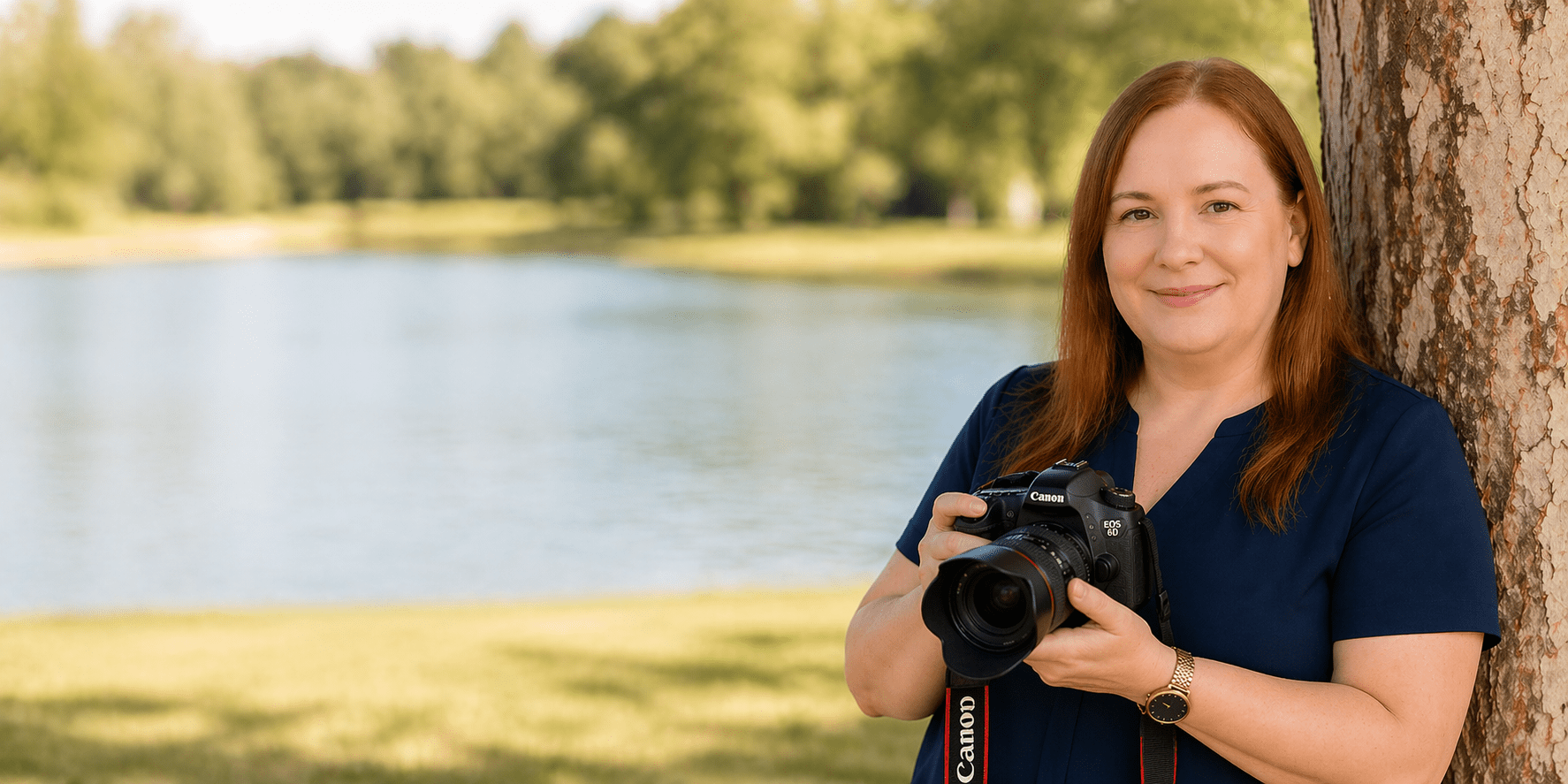 Sherry Edith Dansby holding her camera beside a lake